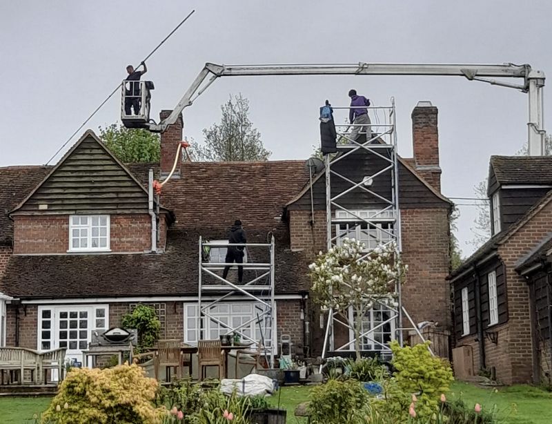 The Roof Moss Cleaners using cherry picker and scaffolding to clean roof safely and professionally in Croxley Green, Hertfordshire